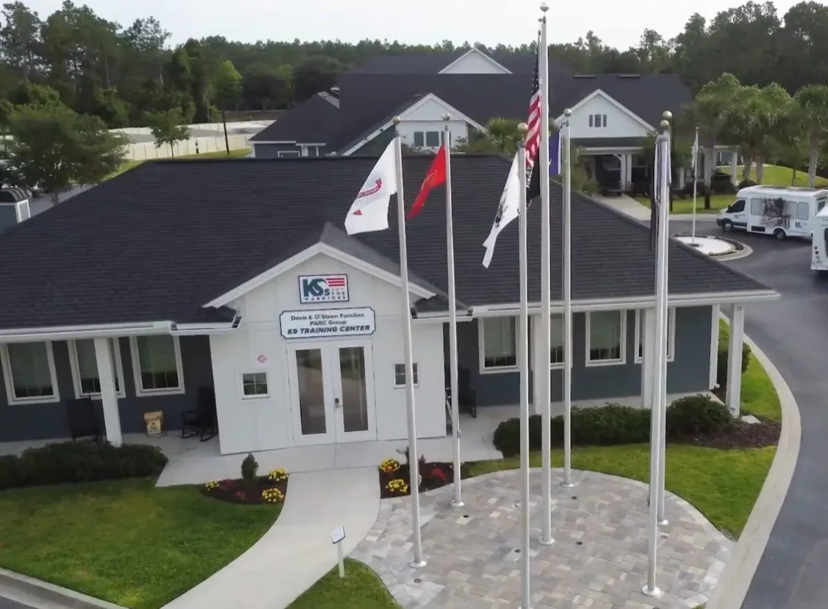 Aerial view of the K9s For Warriors K9 Training Center with flags flying out front